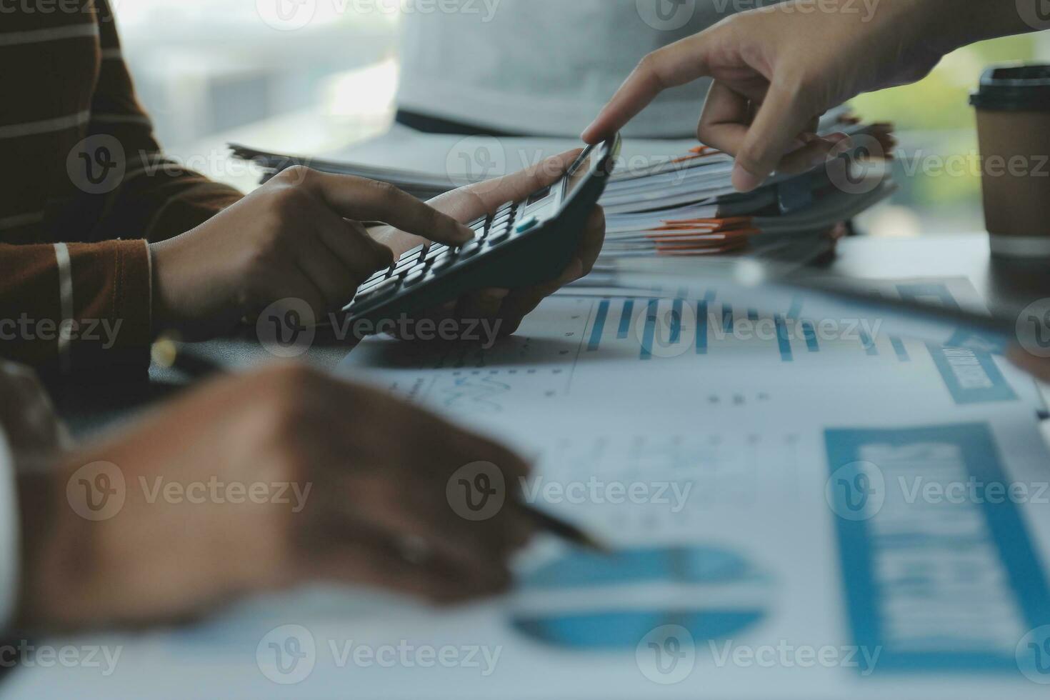 Financial analysts analyze business financial reports on a digital tablet planning investment project during a discussion at a meeting of corporate showing the results of their successful teamwork. photo