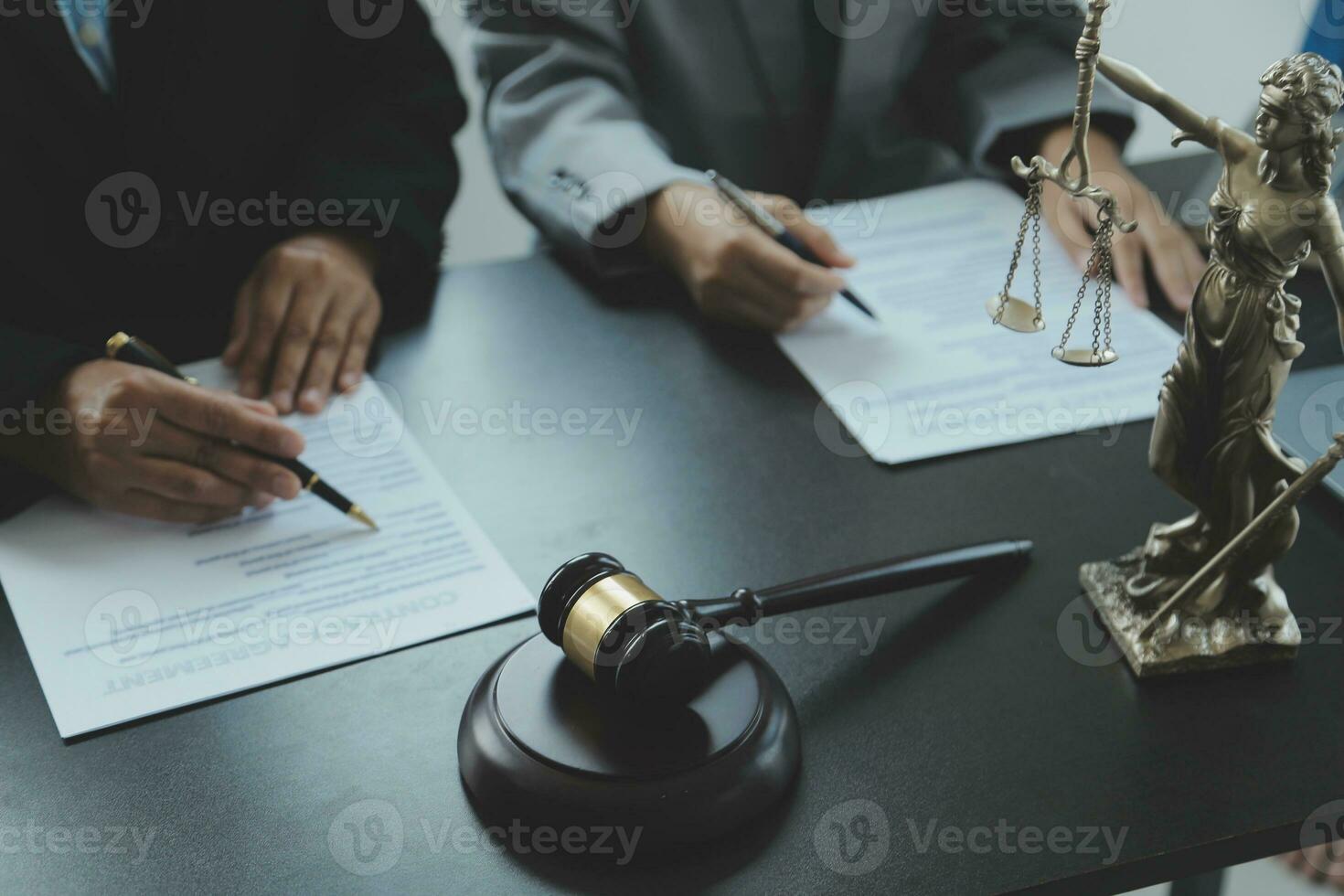 Business and lawyers discussing contract papers with brass scale on desk in office. Law, legal services, advice, justice and law concept picture with film grain effect photo