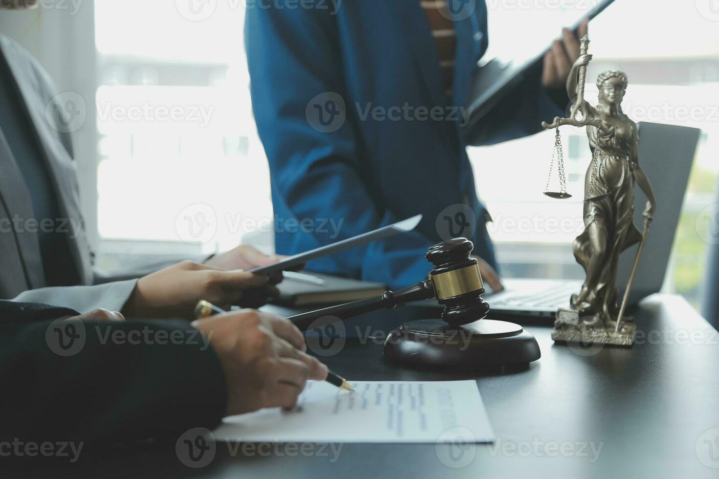 Business and lawyers discussing contract papers with brass scale on desk in office. Law, legal services, advice, justice and law concept picture with film grain effect photo