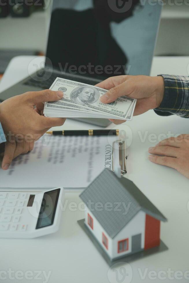 Real estate agent and customer signing contract to buy house, insurance or loan real estate.rent a house,get insurance or loan real estate or property. photo