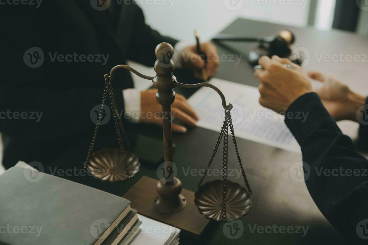 Business and lawyers discussing contract papers with brass scale on desk in office. Law, legal services, advice, justice and law concept picture with film grain effect photo