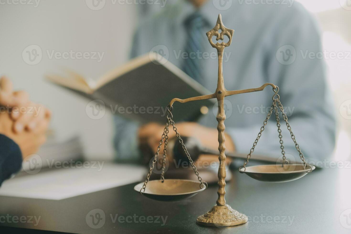 Business and lawyers discussing contract papers with brass scale on desk in office. Law, legal services, advice, justice and law concept picture with film grain effect photo