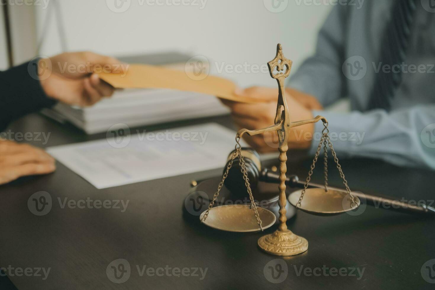 Business and lawyers discussing contract papers with brass scale on desk in office. Law, legal services, advice, justice and law concept picture with film grain effect photo