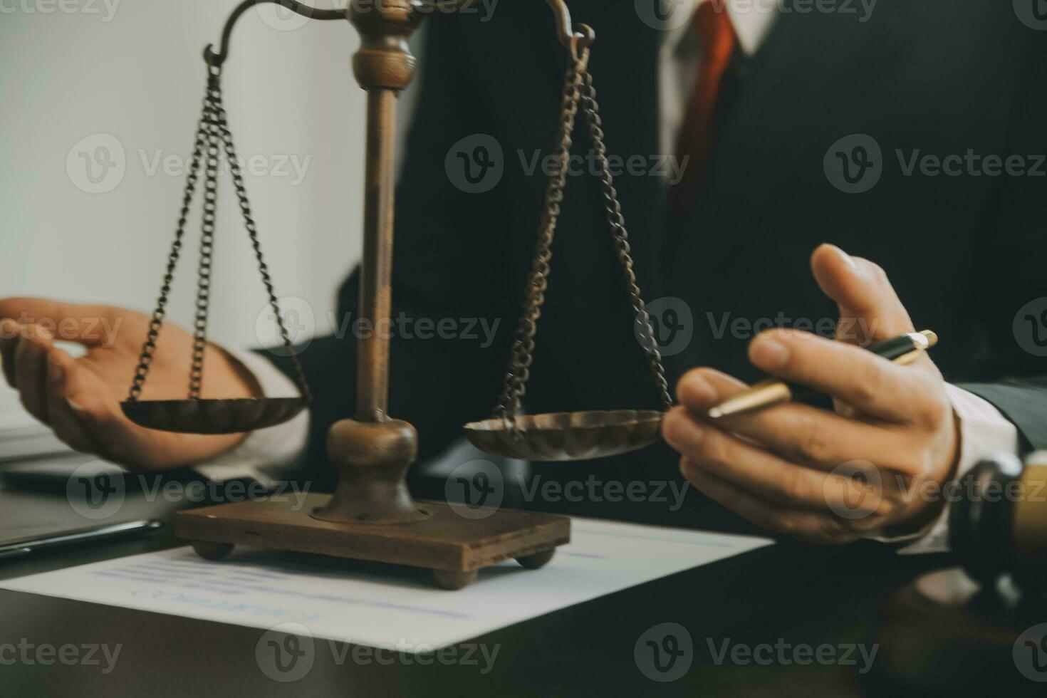 Business and lawyers discussing contract papers with brass scale on desk in office. Law, legal services, advice, justice and law concept picture with film grain effect photo