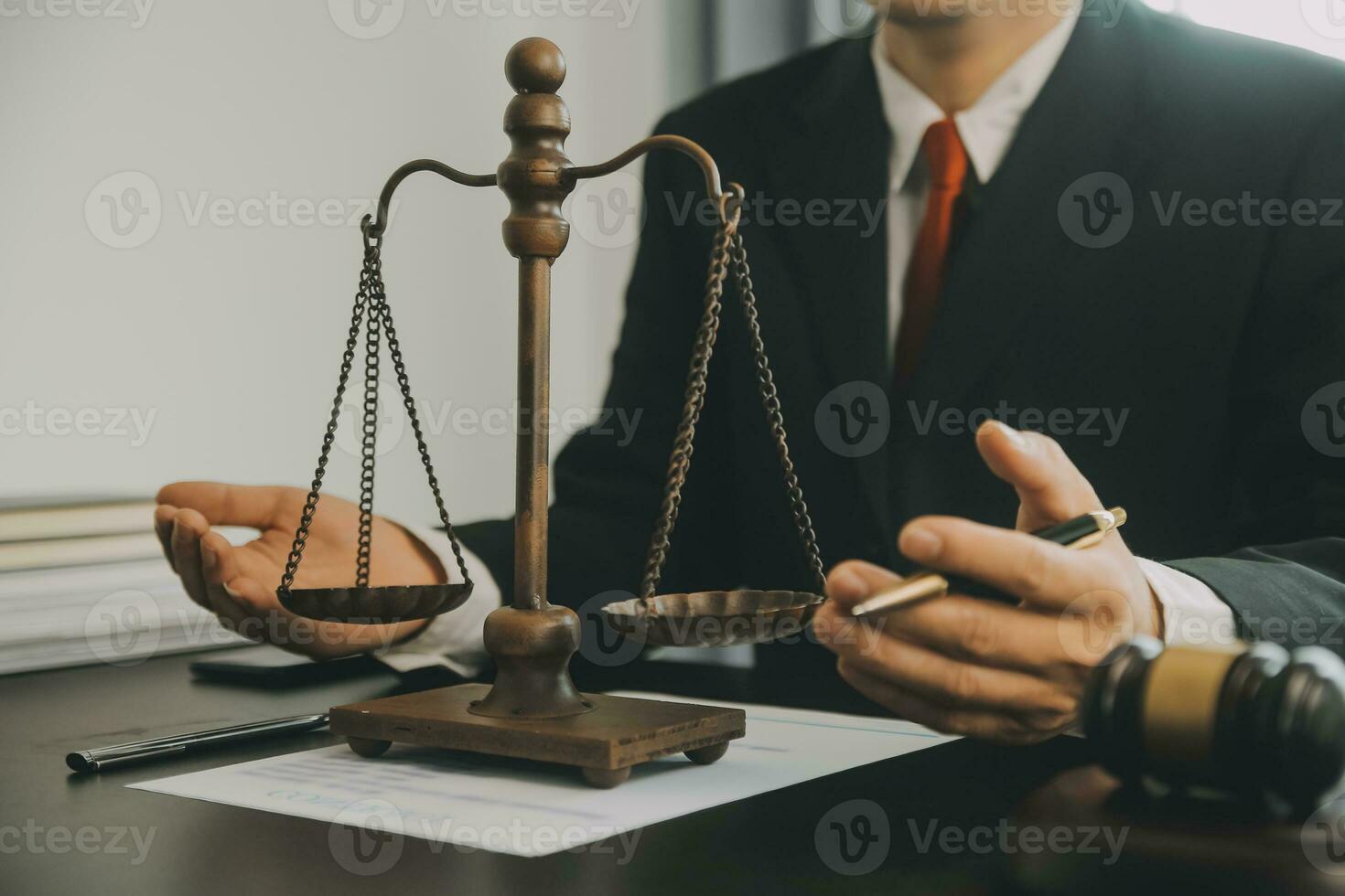 Business and lawyers discussing contract papers with brass scale on desk in office. Law, legal services, advice, justice and law concept picture with film grain effect photo
