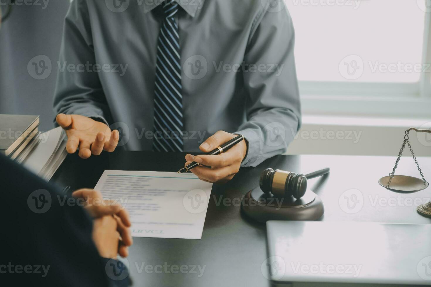 Business and lawyers discussing contract papers with brass scale on desk in office. Law, legal services, advice, justice and law concept picture with film grain effect photo