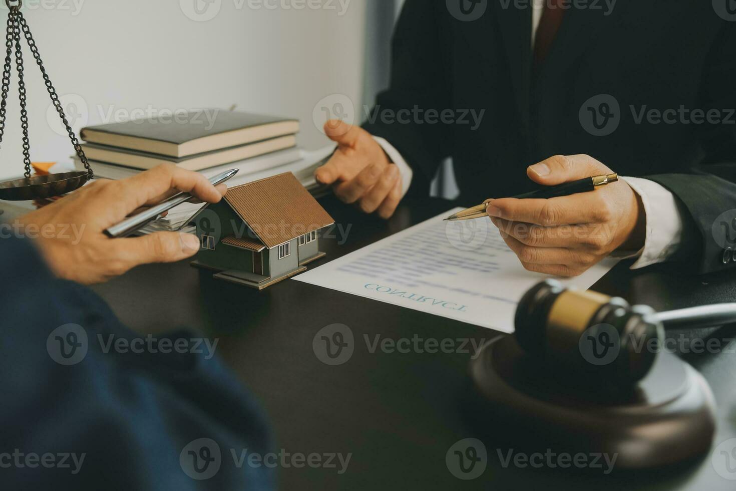 Business and lawyers discussing contract papers with brass scale on desk in office. Law, legal services, advice, justice and law concept picture with film grain effect photo