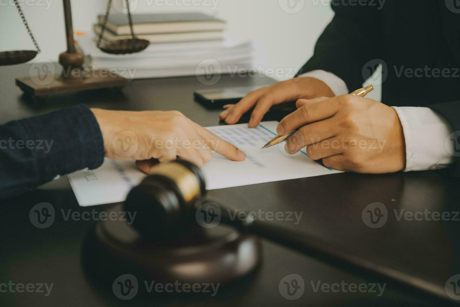 Business and lawyers discussing contract papers with brass scale on desk in office. Law, legal services, advice, justice and law concept picture with film grain effect photo
