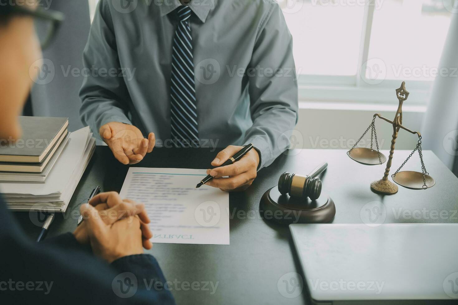 Business and lawyers discussing contract papers with brass scale on desk in office. Law, legal services, advice, justice and law concept picture with film grain effect photo