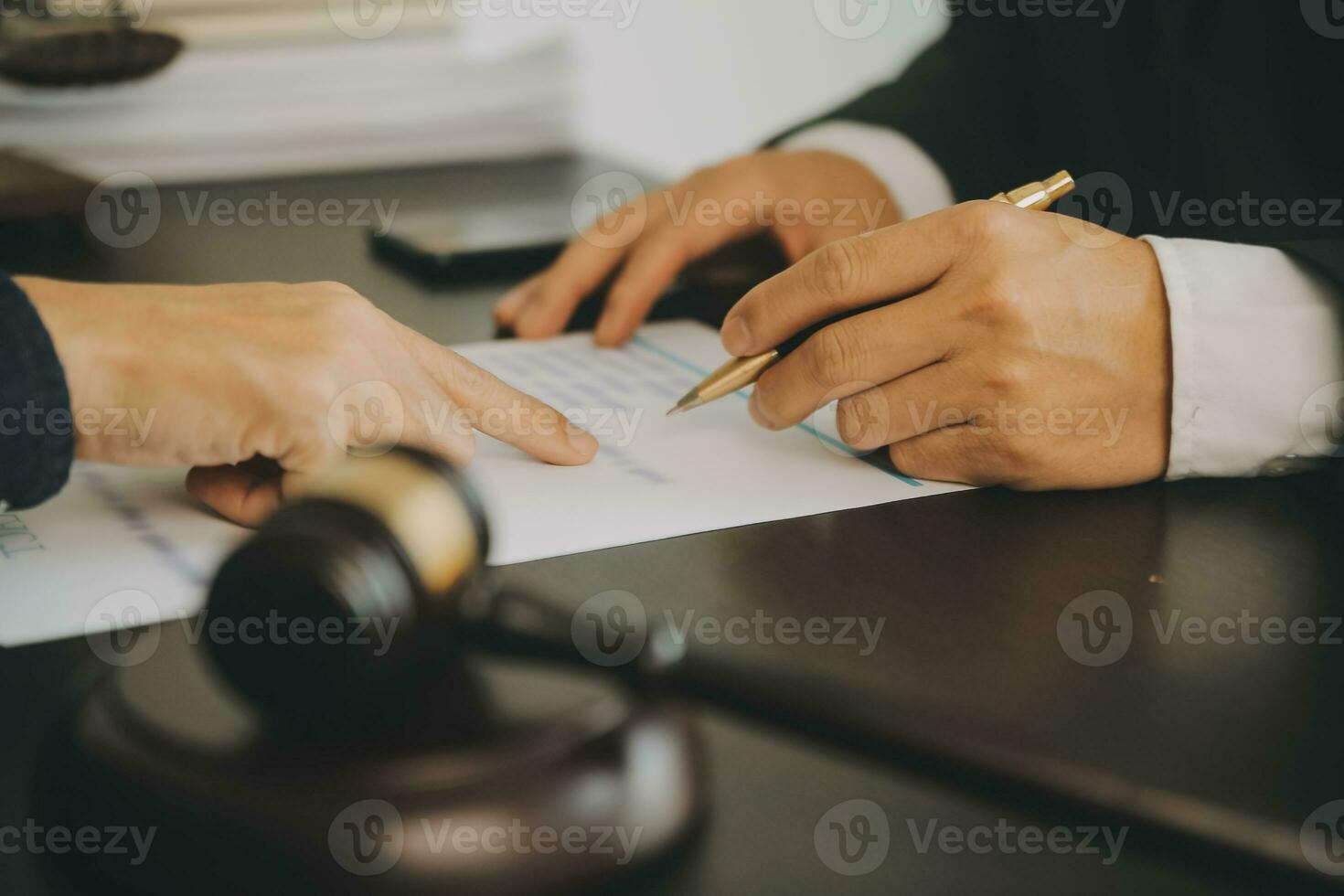 Business and lawyers discussing contract papers with brass scale on desk in office. Law, legal services, advice, justice and law concept picture with film grain effect photo
