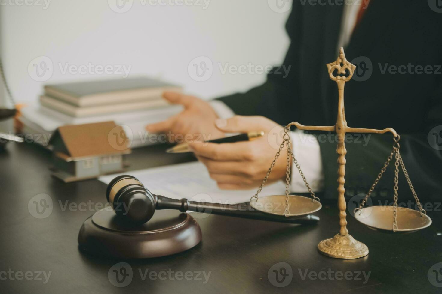 Business and lawyers discussing contract papers with brass scale on desk in office. Law, legal services, advice, justice and law concept picture with film grain effect photo