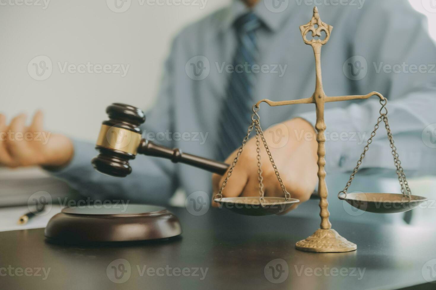 Business and lawyers discussing contract papers with brass scale on desk in office. Law, legal services, advice, justice and law concept picture with film grain effect photo
