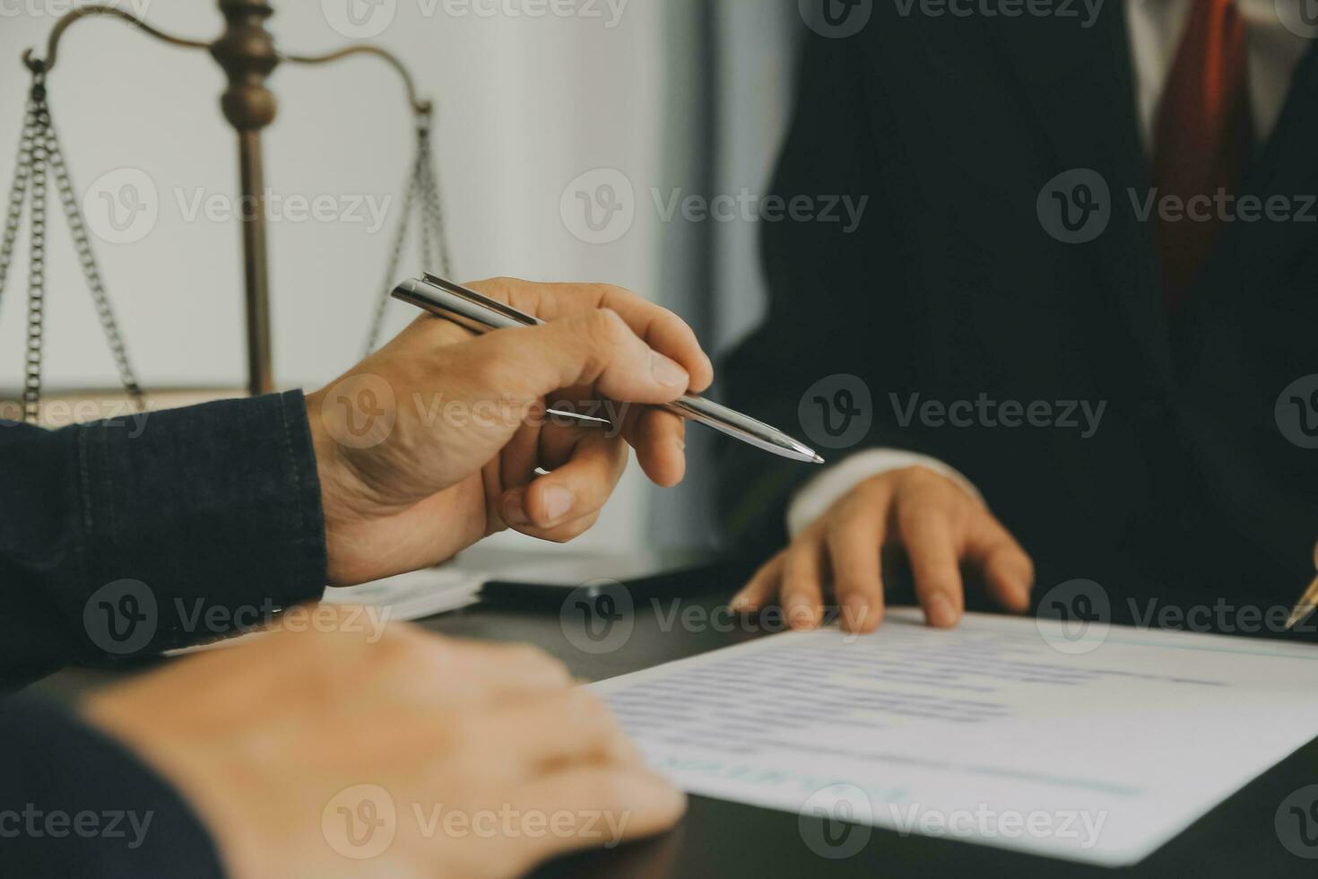 Business and lawyers discussing contract papers with brass scale on desk in office. Law, legal services, advice, justice and law concept picture with film grain effect photo