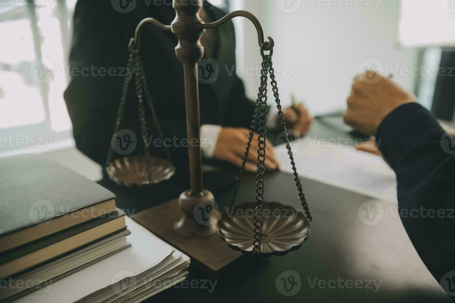 Business and lawyers discussing contract papers with brass scale on desk in office. Law, legal services, advice, justice and law concept picture with film grain effect photo