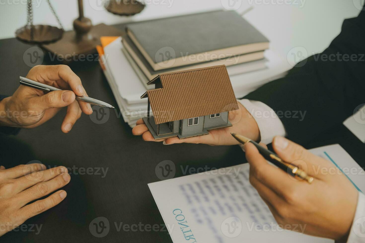 Business and lawyers discussing contract papers with brass scale on desk in office. Law, legal services, advice, justice and law concept picture with film grain effect photo