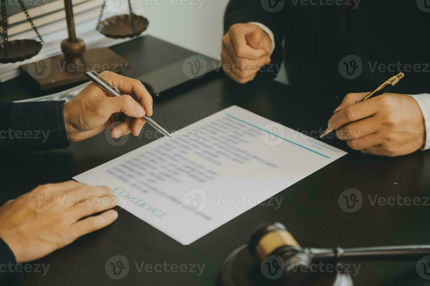 Business and lawyers discussing contract papers with brass scale on desk in office. Law, legal services, advice, justice and law concept picture with film grain effect photo