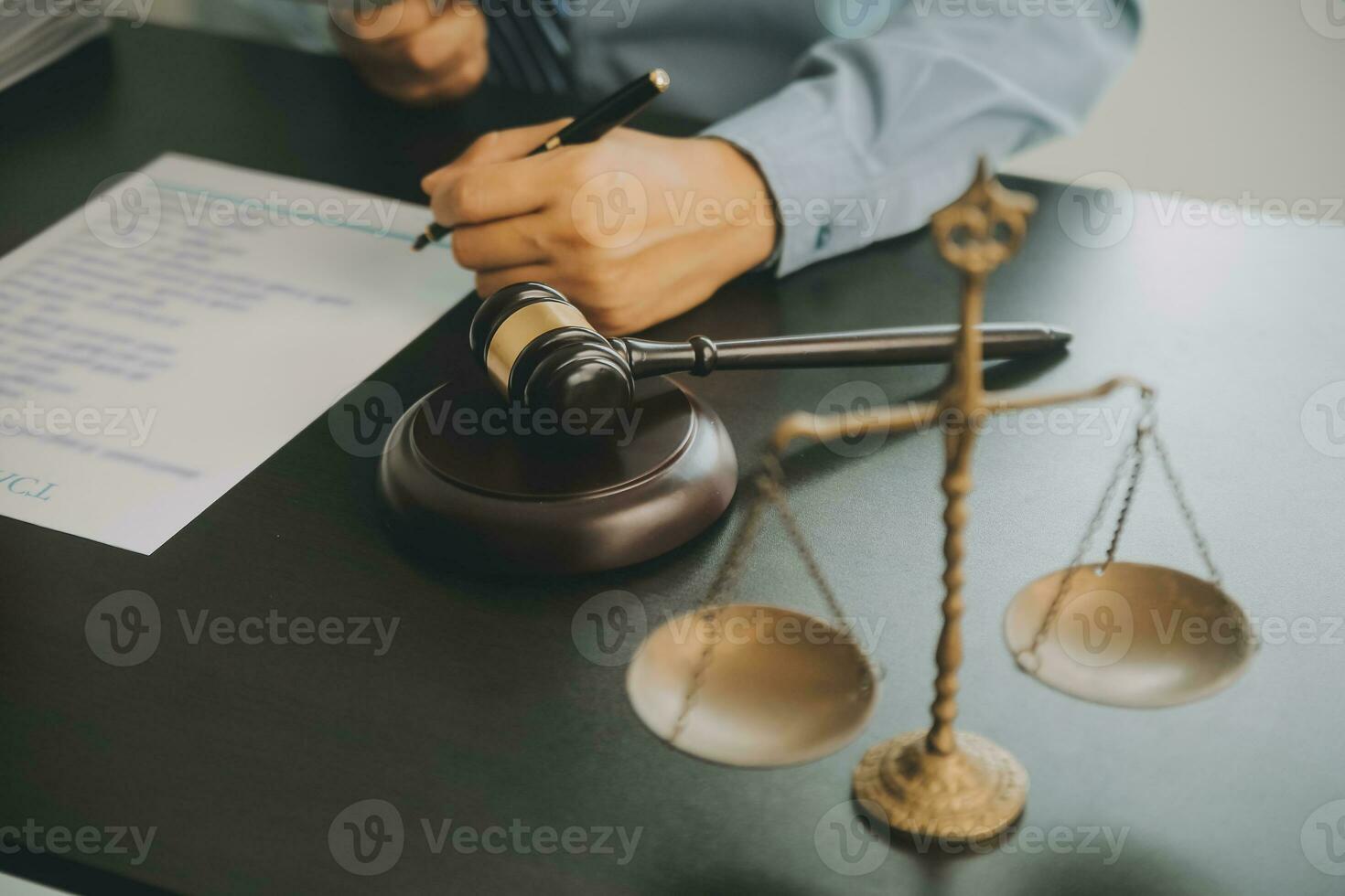 Business and lawyers discussing contract papers with brass scale on desk in office. Law, legal services, advice, justice and law concept picture with film grain effect photo