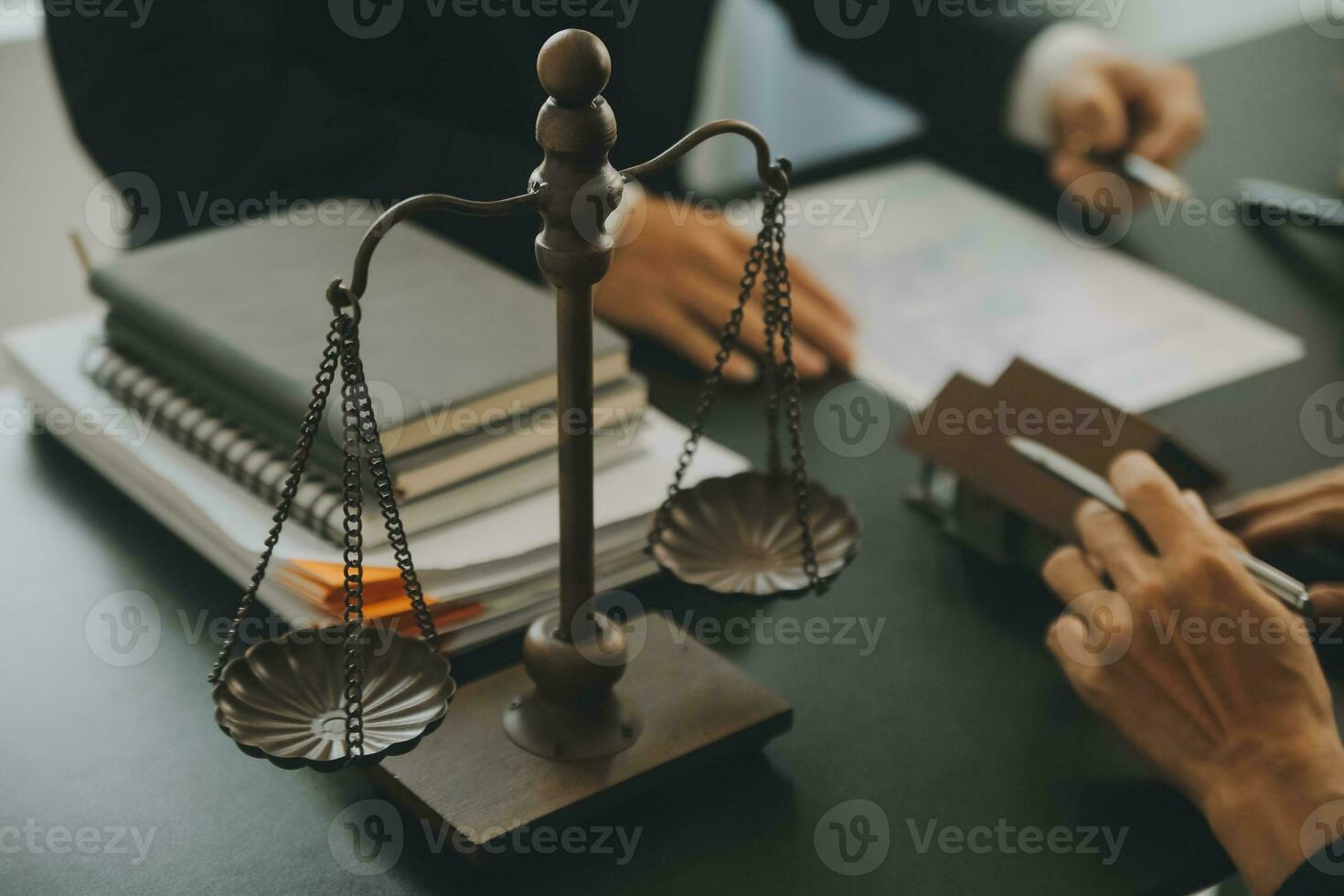 Business and lawyers discussing contract papers with brass scale on desk in office. Law, legal services, advice, justice and law concept picture with film grain effect photo