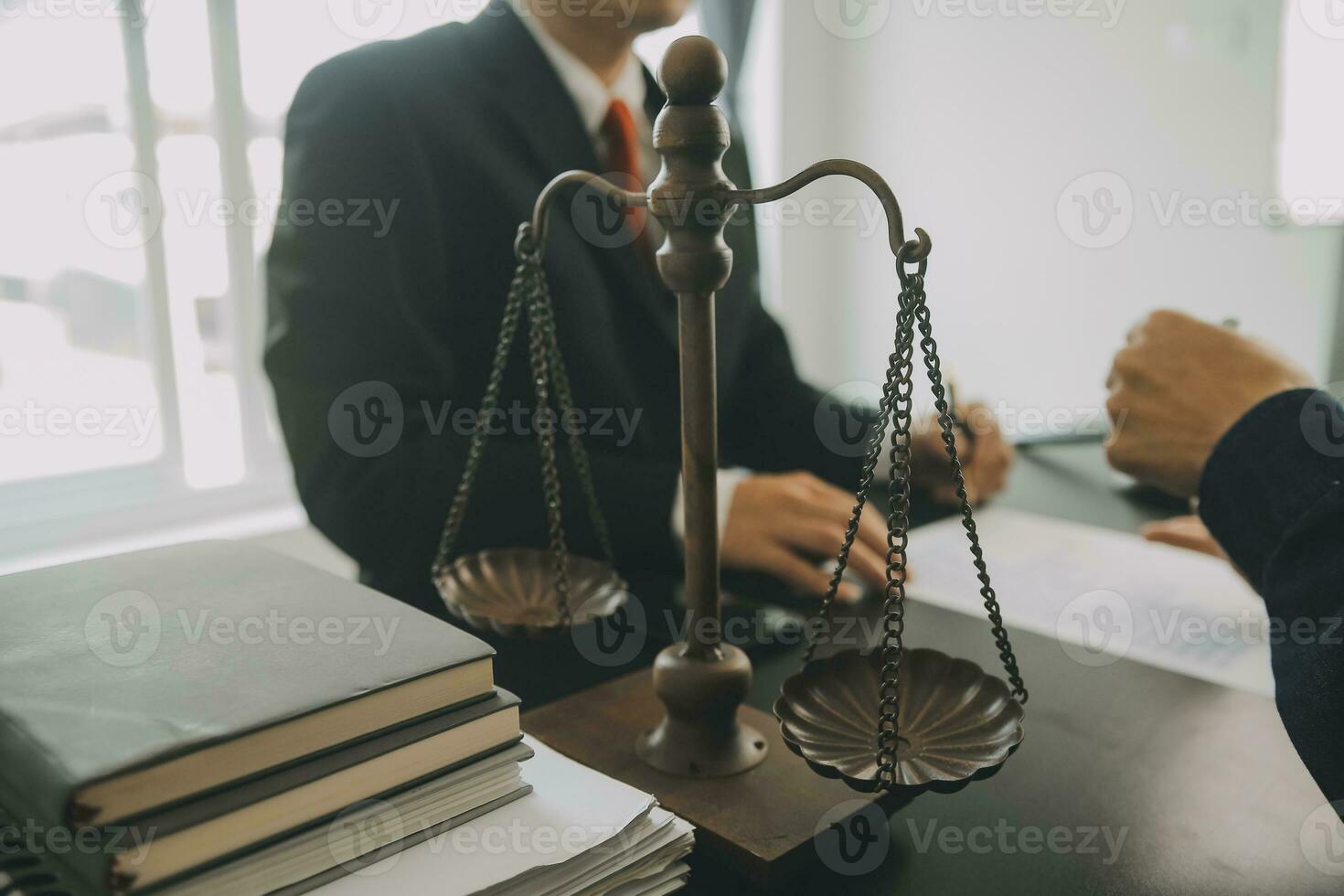 Business and lawyers discussing contract papers with brass scale on desk in office. Law, legal services, advice, justice and law concept picture with film grain effect photo