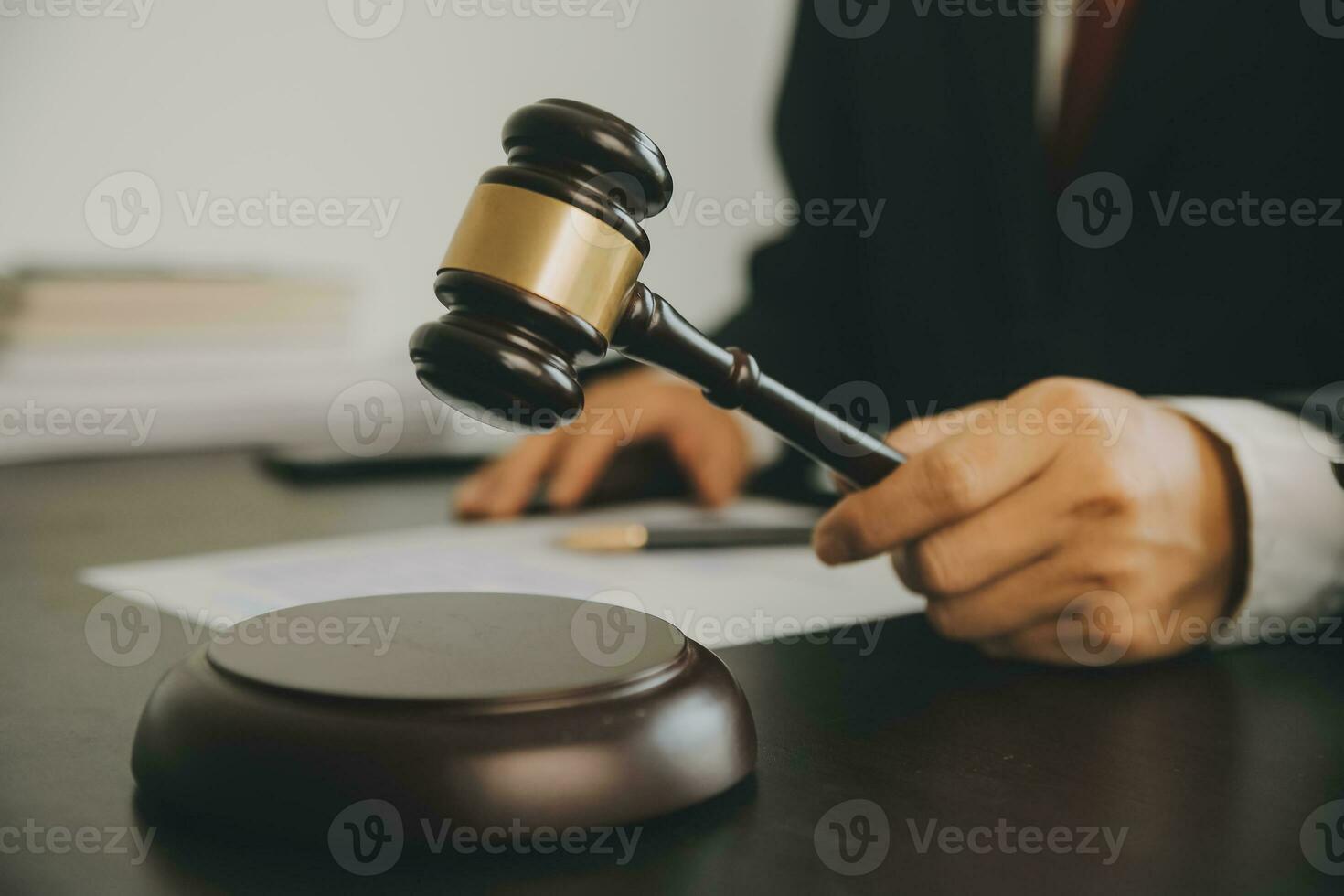 Business and lawyers discussing contract papers with brass scale on desk in office. Law, legal services, advice, justice and law concept picture with film grain effect photo