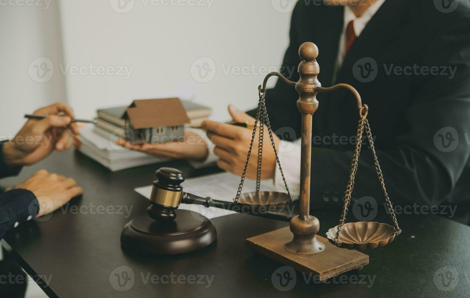 Business and lawyers discussing contract papers with brass scale on desk in office. Law, legal services, advice, justice and law concept picture with film grain effect photo