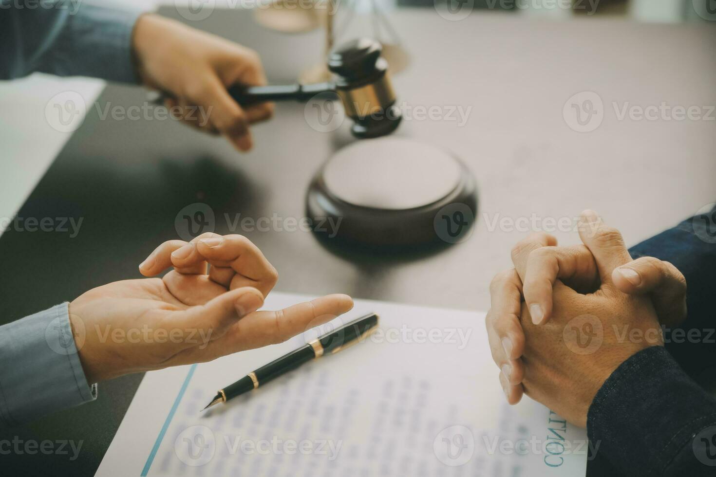 Business and lawyers discussing contract papers with brass scale on desk in office. Law, legal services, advice, justice and law concept picture with film grain effect photo