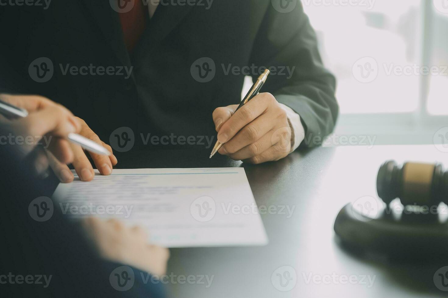 Business and lawyers discussing contract papers with brass scale on desk in office. Law, legal services, advice, justice and law concept picture with film grain effect photo