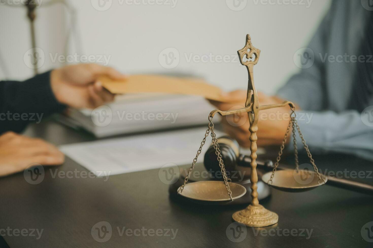 Business and lawyers discussing contract papers with brass scale on desk in office. Law, legal services, advice, justice and law concept picture with film grain effect photo