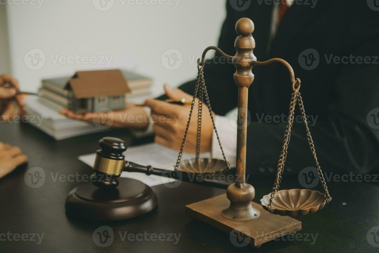 Business and lawyers discussing contract papers with brass scale on desk in office. Law, legal services, advice, justice and law concept picture with film grain effect photo