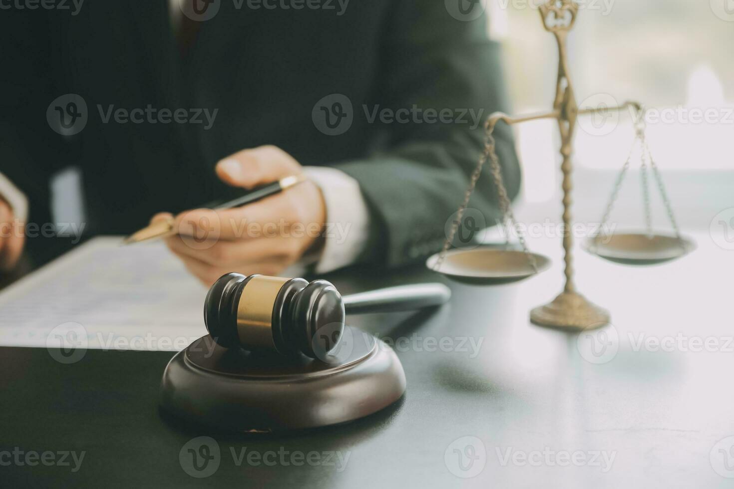 Business and lawyers discussing contract papers with brass scale on desk in office. Law, legal services, advice, justice and law concept picture with film grain effect photo