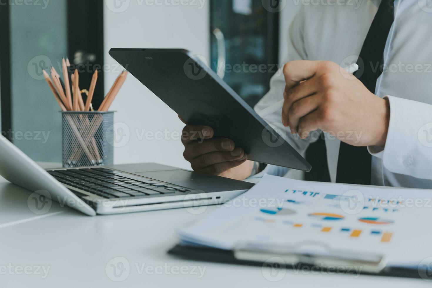 Close up of Business team analyzing income charts and graphs with modern laptop computer. Business analysis and strategy concept. photo