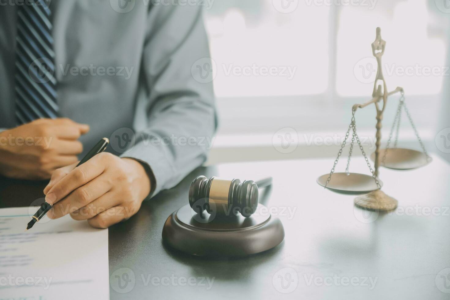 Business and lawyers discussing contract papers with brass scale on desk in office. Law, legal services, advice, justice and law concept picture with film grain effect photo
