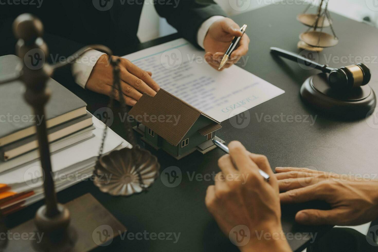 Business and lawyers discussing contract papers with brass scale on desk in office. Law, legal services, advice, justice and law concept picture with film grain effect photo