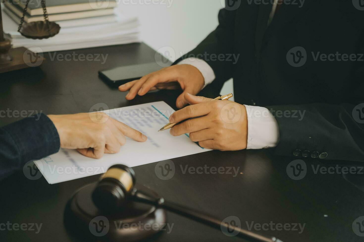 Business and lawyers discussing contract papers with brass scale on desk in office. Law, legal services, advice, justice and law concept picture with film grain effect photo