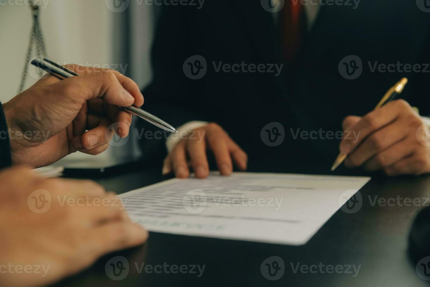 Lawyer, legal advisor, businessman brainstorming information on agreement details Business contracts in legal processing books for accuracy in contract documents. joint financial investment. photo