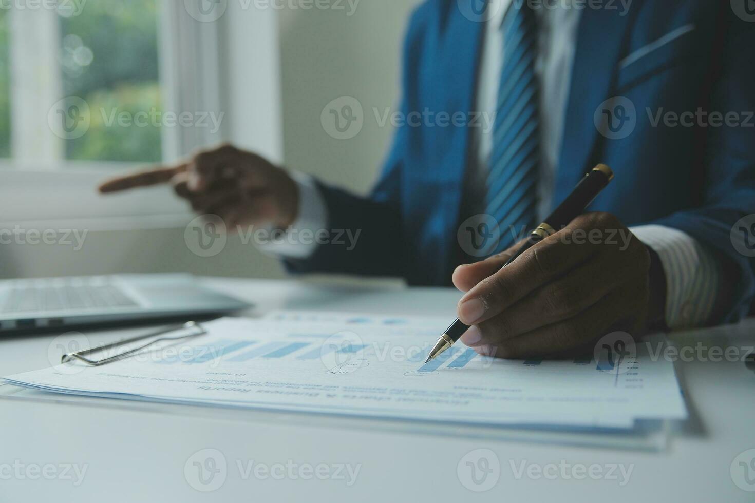 Close up Business woman using calculator and laptop for do math finance on wooden desk, tax, accounting, statistics and analytical research concept photo