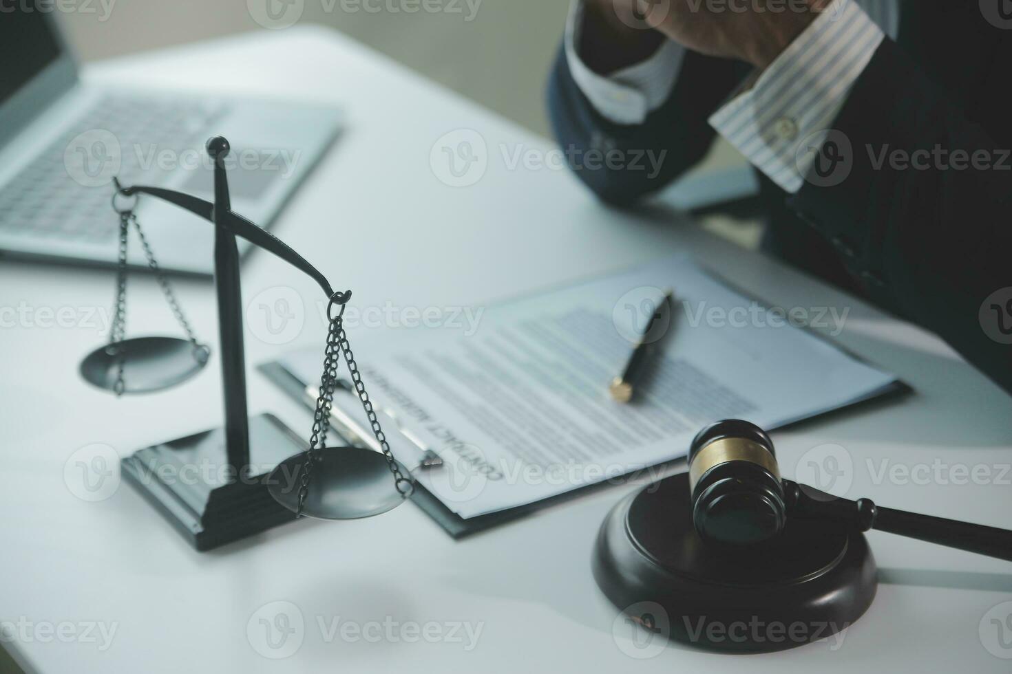 Business and lawyers discussing contract papers with brass scale on desk in office. Law, legal services, advice, justice and law concept picture with film grain effect photo
