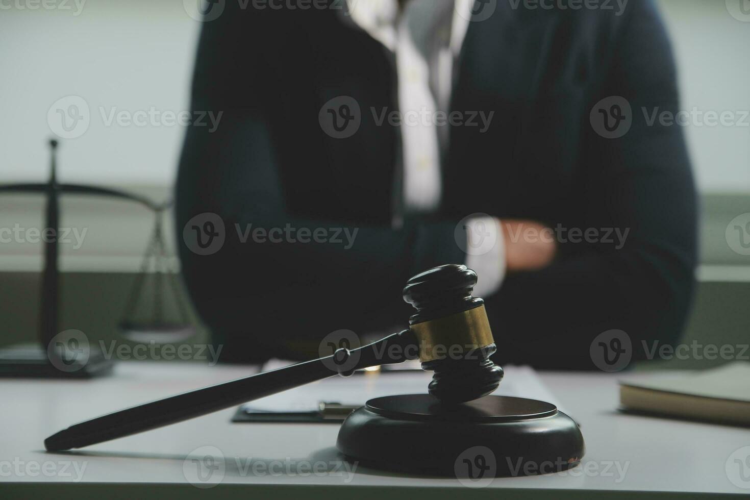 Business and lawyers discussing contract papers with brass scale on desk in office. Law, legal services, advice, justice and law concept picture with film grain effect photo