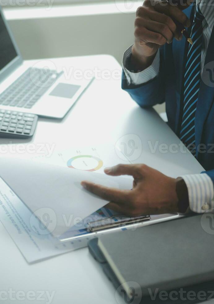 Close up Business woman using calculator and laptop for do math finance on wooden desk, tax, accounting, statistics and analytical research concept photo
