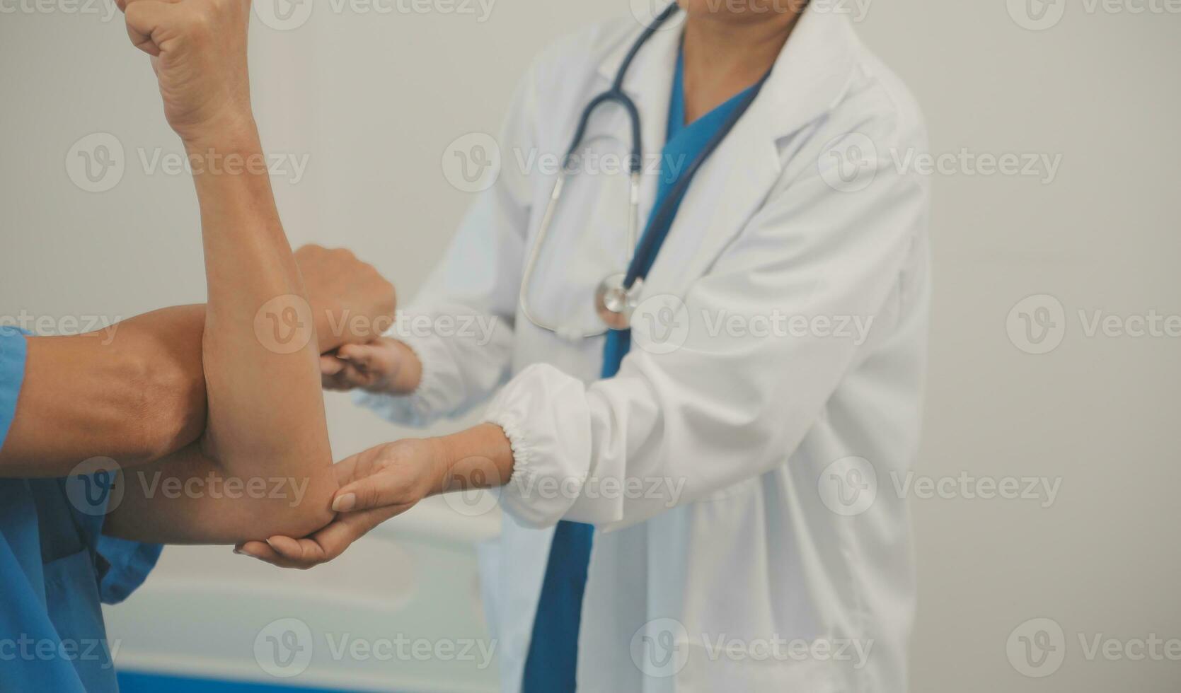 Asian older aged man doing physiotherapist with support from nurse. Senior elderly male sitting on sofa in living room using dumbbells workout exercise for patient with caregiver in nursing care. photo
