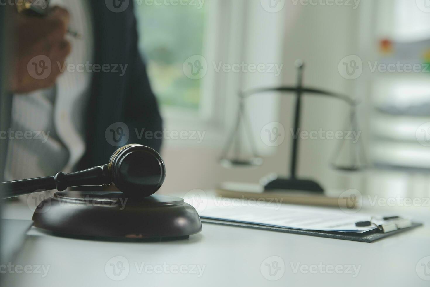 Business and lawyers discussing contract papers with brass scale on desk in office. Law, legal services, advice, justice and law concept picture with film grain effect photo