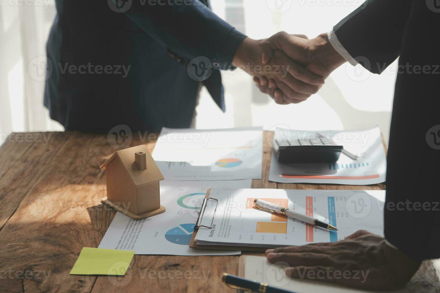 Real estate brokerage agent Deliver a sample of a model house to the customer, mortgage loan agreement Making lease and buy and sell house And contract home insurance mortgage loan concept photo