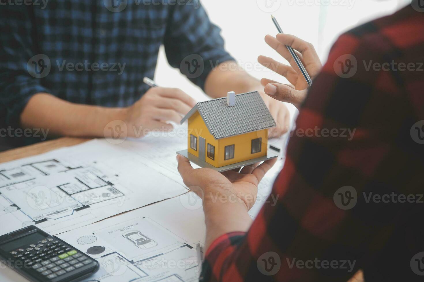 Close up of civil male engineer asian working on blueprint architectural project at construction site at desk in office. photo
