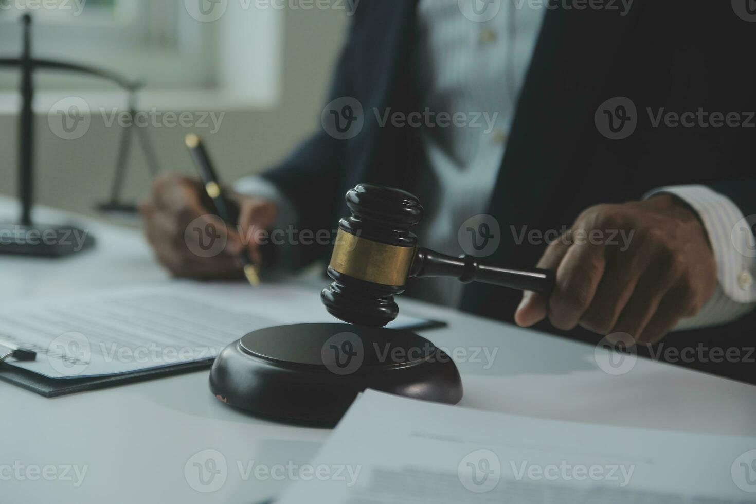 Business and lawyers discussing contract papers with brass scale on desk in office. Law, legal services, advice, justice and law concept picture with film grain effect photo