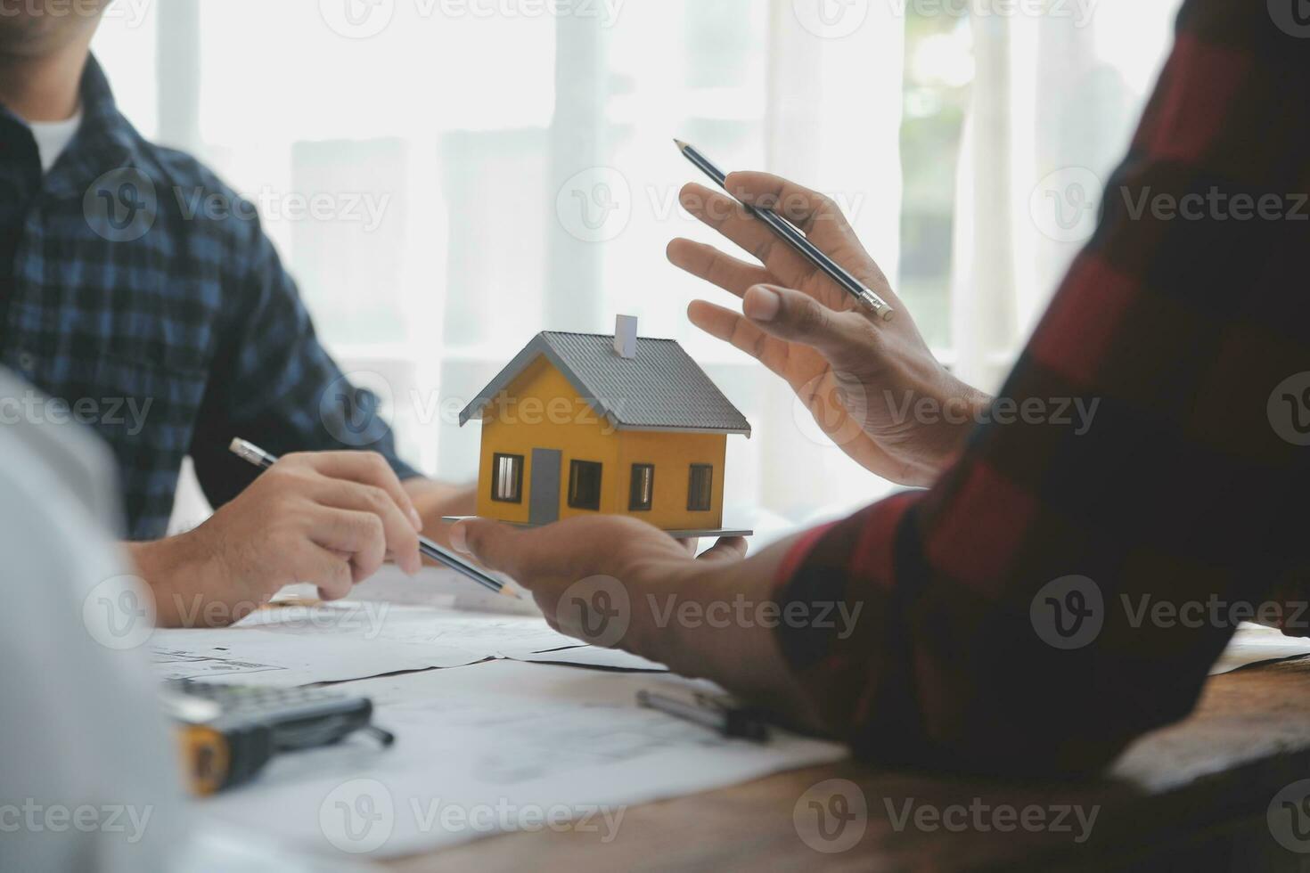 Close up of civil male engineer asian working on blueprint architectural project at construction site at desk in office. photo