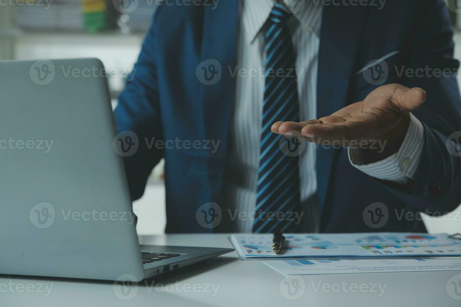 Close up Business woman using calculator and laptop for do math finance on wooden desk, tax, accounting, statistics and analytical research concept photo