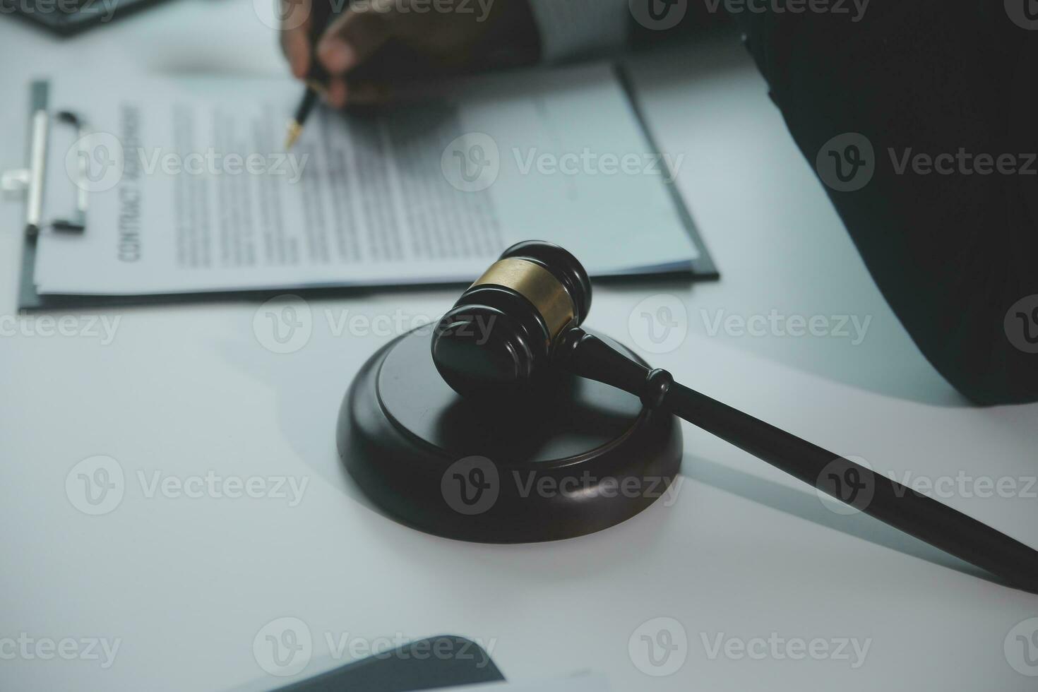 Business and lawyers discussing contract papers with brass scale on desk in office. Law, legal services, advice, justice and law concept picture with film grain effect photo