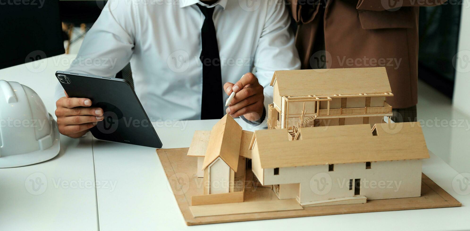 Construction and structure concept of Engineer or architect meeting for project working with partner and engineering tools on model building and blueprint in working site, contract for both companies. photo