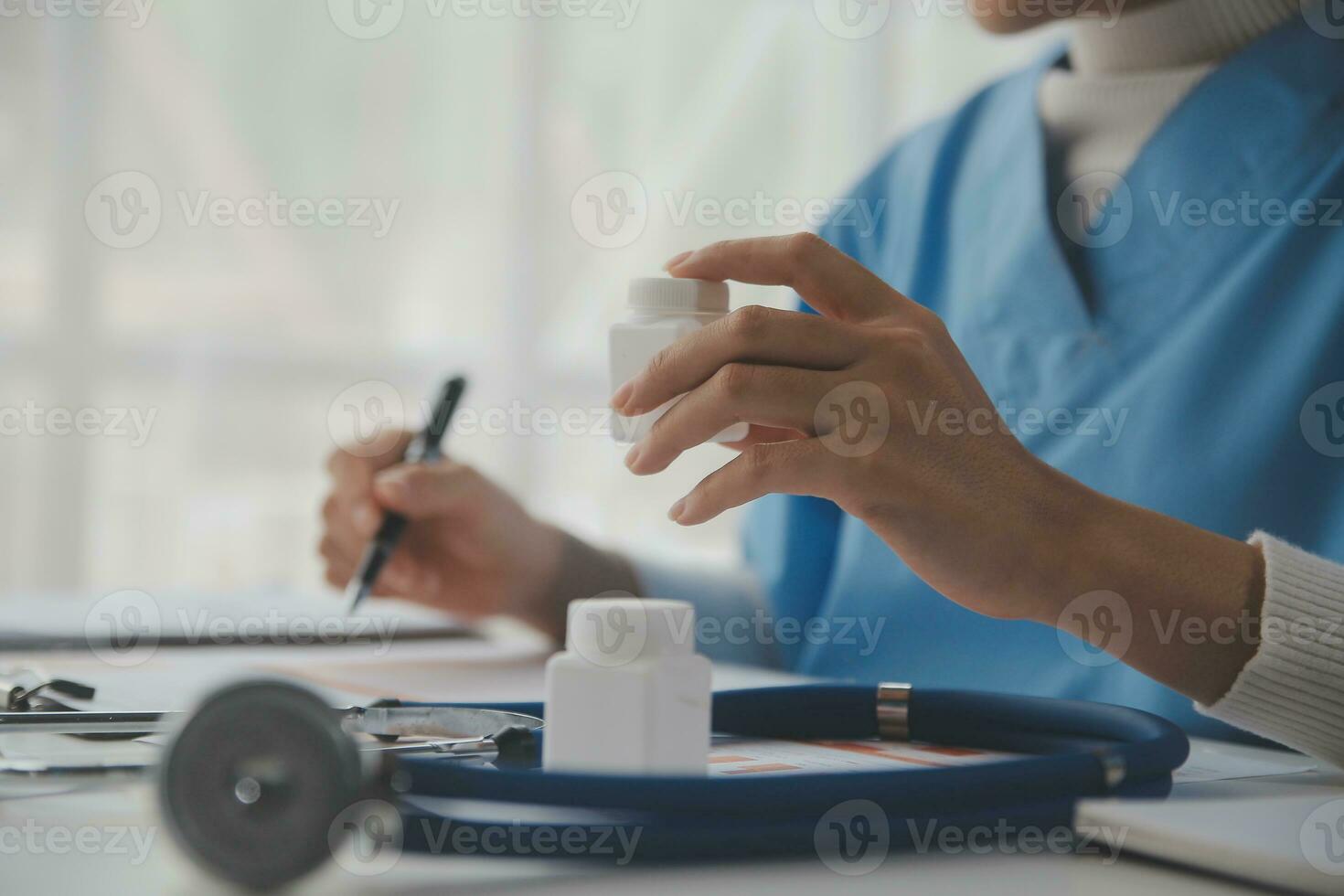Stethoscope and background doctor using laptop at desk in clinic working on computer at room office. photo