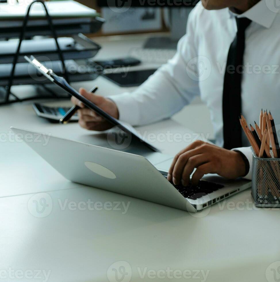 Close up of Business team analyzing income charts and graphs with modern laptop computer. Business analysis and strategy concept. photo